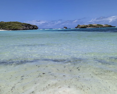 Shallow turquoise lagoon, coral reef and coastal islets in Watamu, Kenya.