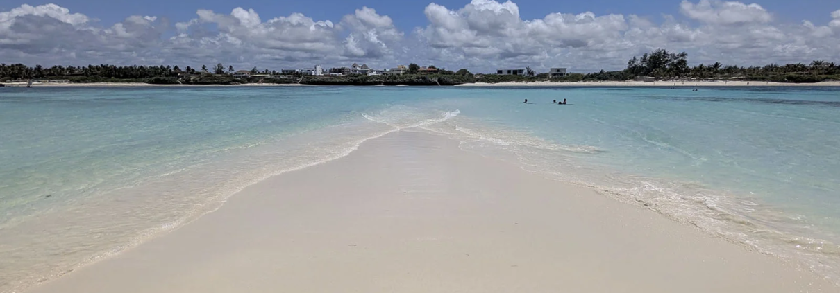 Love Island in Watamu, Kenya, visible at low tide across the coral reef.