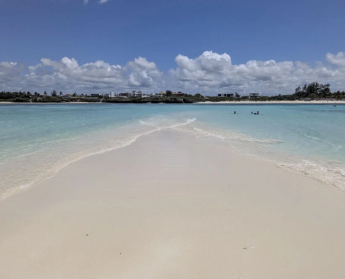 Love Island in Watamu, Kenya, visible at low tide across the coral reef.