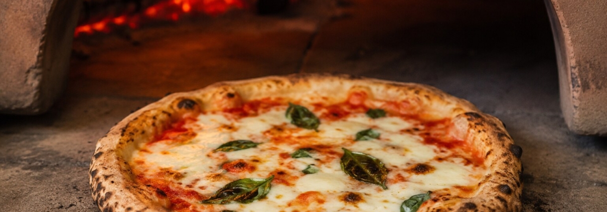 Authentic uncut wood-fired pizza baking at Visiwa Restaurant in Watamu