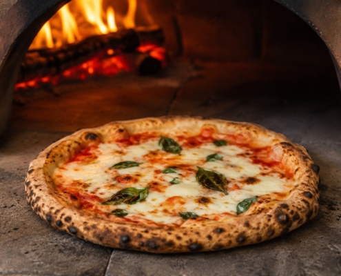 Authentic uncut wood-fired pizza baking at Visiwa Restaurant in Watamu