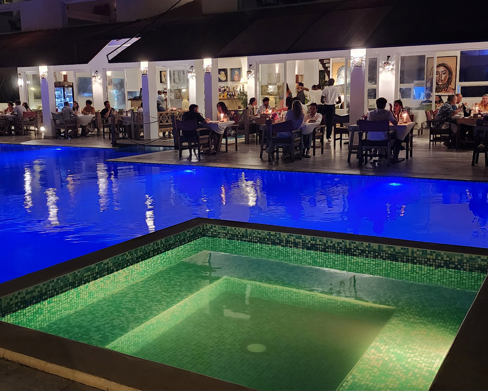Evening dinner beside the illuminated pool at Visiwa Beach Resort in Watamu