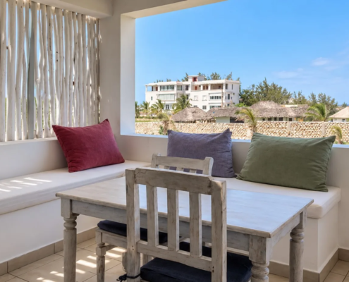 Family Suite living area with sofa and dining table at Visiwa Beach Resort, Watamu