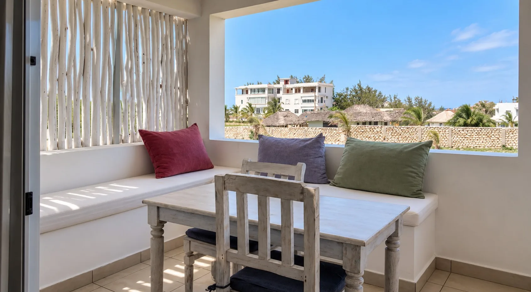Family Suite living area with sofa and dining table at Visiwa Beach Resort, Watamu