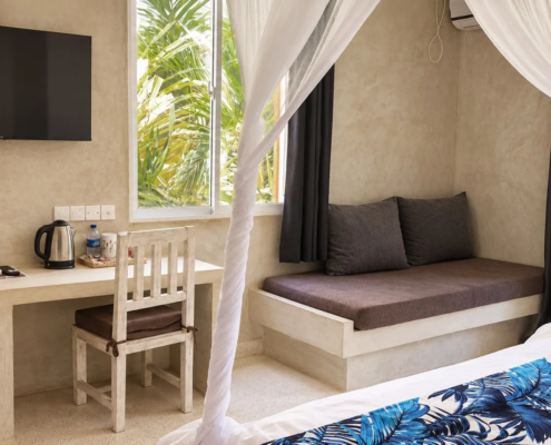 Garden View Room with TV, desk and sofa at Visiwa Beach Resort, Watamu