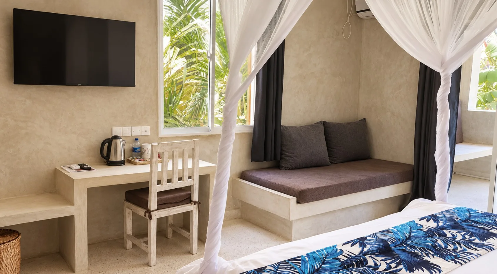 Garden View Room with TV, desk and sofa at Visiwa Beach Resort, Watamu