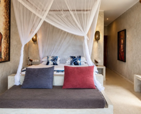 Ocean View Room canopy bed with African artwork at Visiwa Beach Resort, Watamu