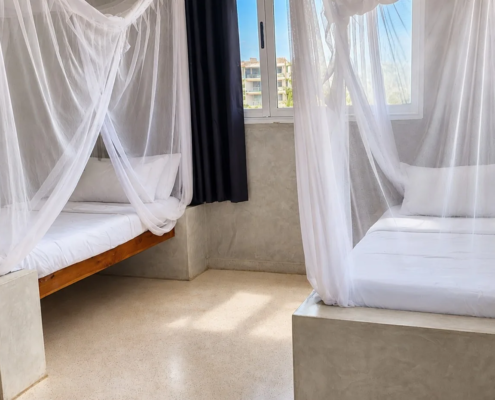 Ocean View Room with two beds and mosquito nets at Visiwa Beach Resort, Watamu