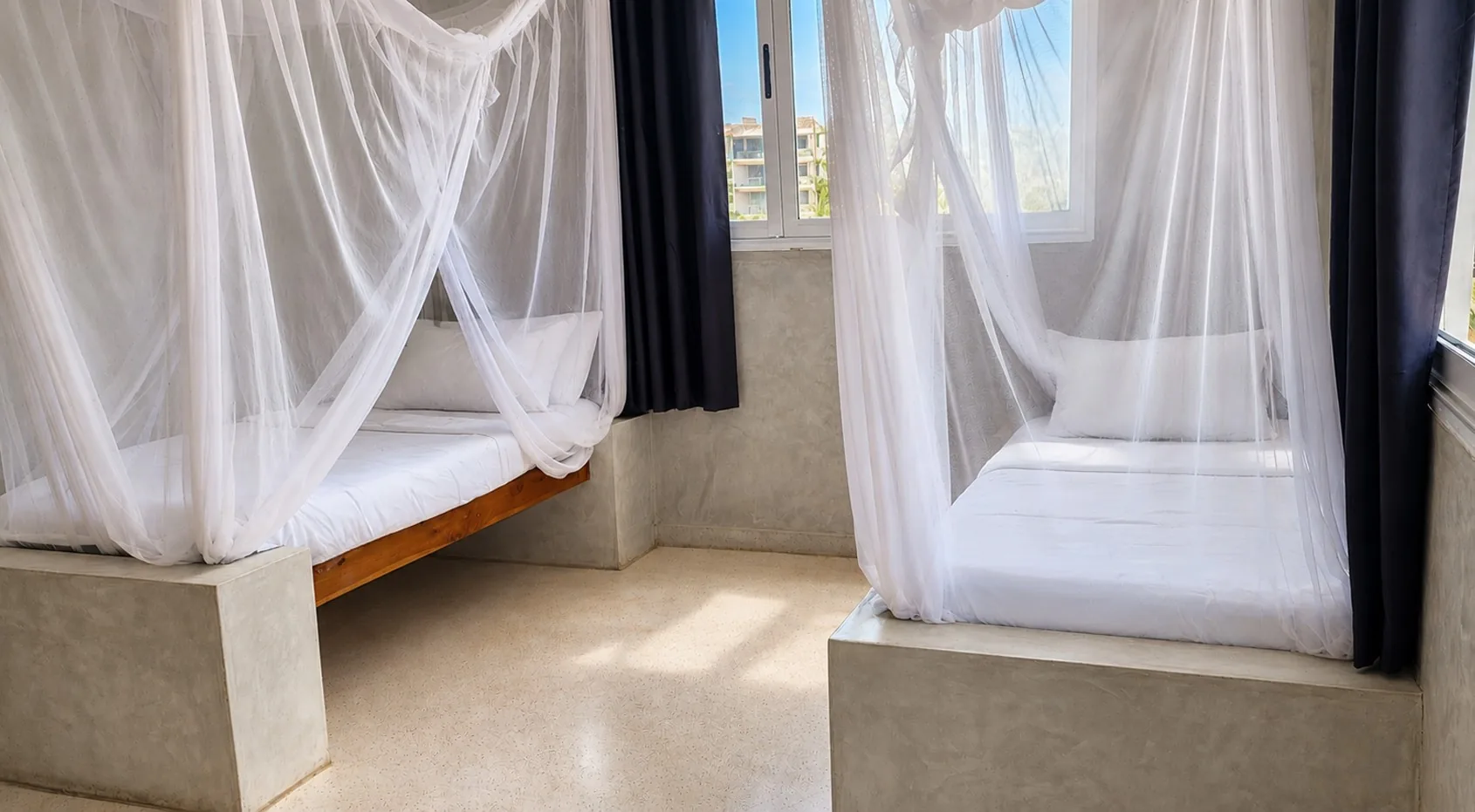 Ocean View Room with two beds and mosquito nets at Visiwa Beach Resort, Watamu