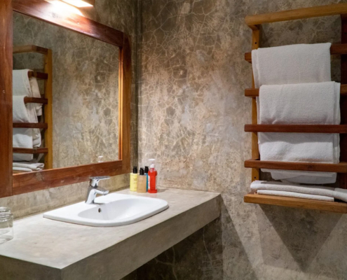 Apartment bathroom with stone washbasin at Visiwa Beach Resort, Watamu