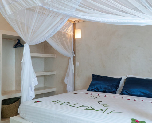 Double bed in the apartment bedroom at Visiwa Beach Resort, Watamu, Kenya
