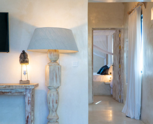 Apartment interior with carved wooden lamp and bedroom door at Visiwa Beach Resort