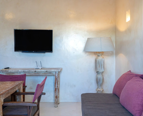 Apartment living area with desk and TV at Visiwa Beach Resort, Watamu